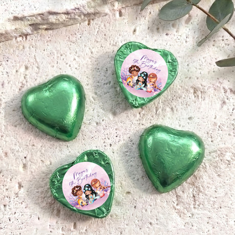 Green foil-covered chocolate hearts with printed birthday message and cartoon mermaids