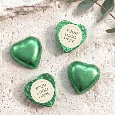 Green foil-covered chocolate hearts with “YOUR LOGO HERE” label