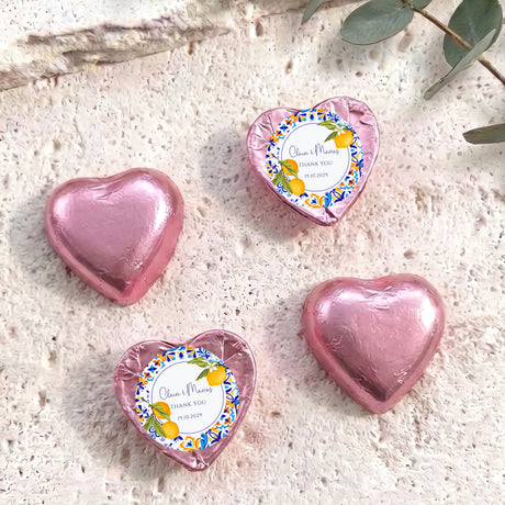 Pink foil-covered chocolate heart favors with thank-you message center labels