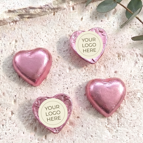 Pink foil-covered chocolate hearts with “YOUR LOGO HERE” label