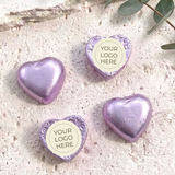 Foil-covered purple chocolate hearts with round personalized logo label