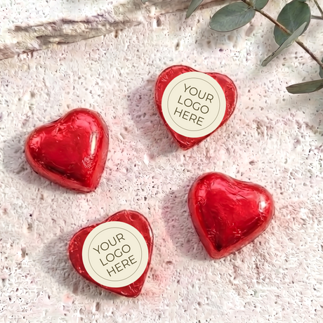 Red foil-covered chocolate hearts with “YOUR LOGO HERE” label