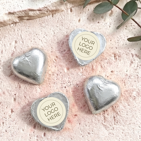 Silver foil-covered chocolate hearts with “YOUR LOGO HERE” label