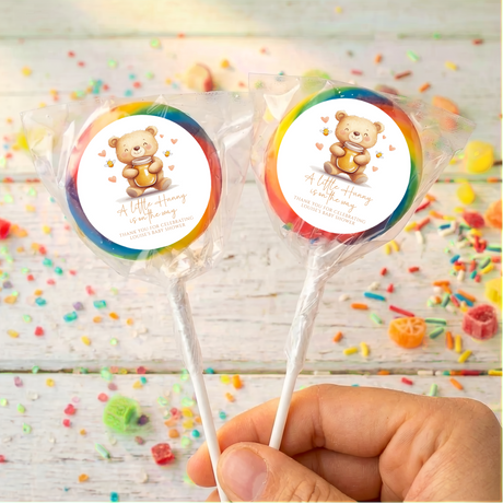 Personalised baby shower lollipops with teddy bear labels on dark blue discs, clear wrap