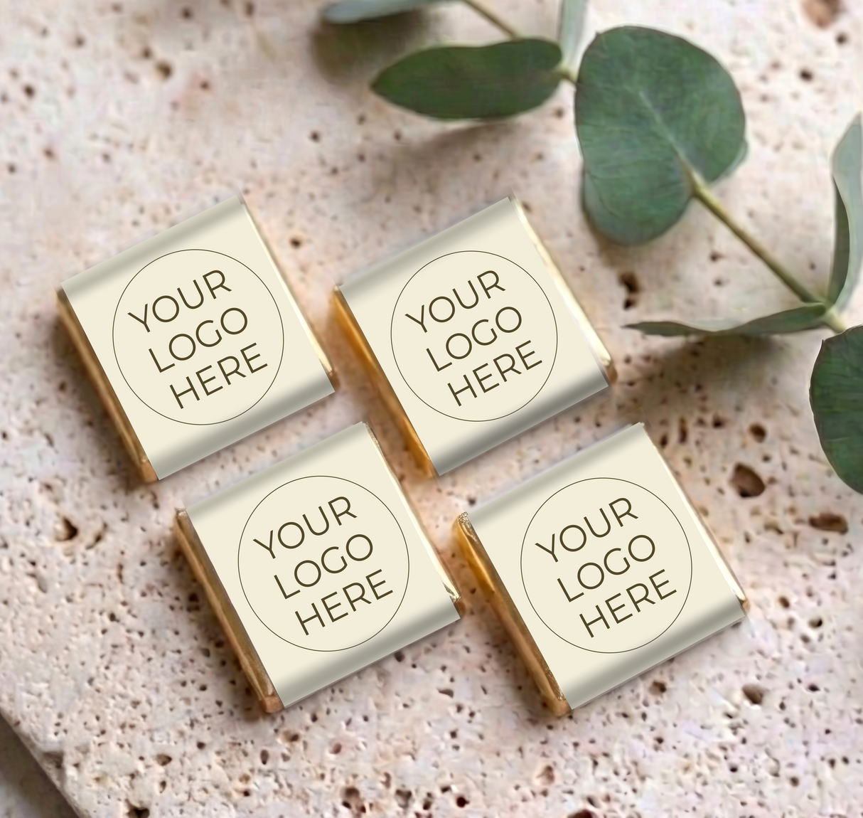 Set of four mini personalized chocolates with “YOUR LOGO HERE” labels on cream wrappers
