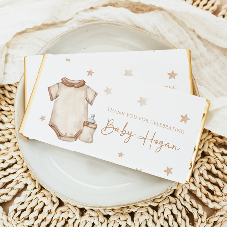 Baby shower chocolate bar with illustrated baby onesie and gold star accents