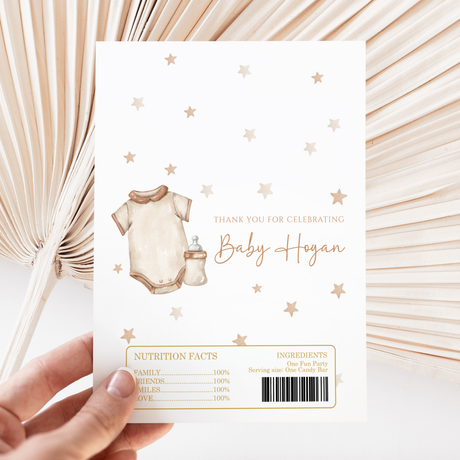 Printed baby-themed chocolate wrapper with onesie, bib, stars, and text panel