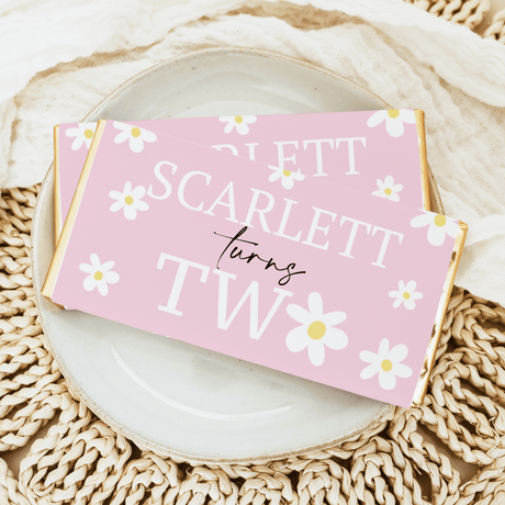 Pink daisy birthday chocolate bar wrapper with '1st' and 'Sweet' lettering