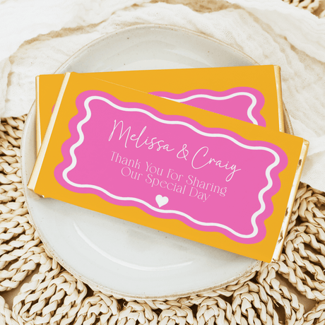 Pink wavy wedding chocolate bar wrapper with orange border, thank-you text and hearts