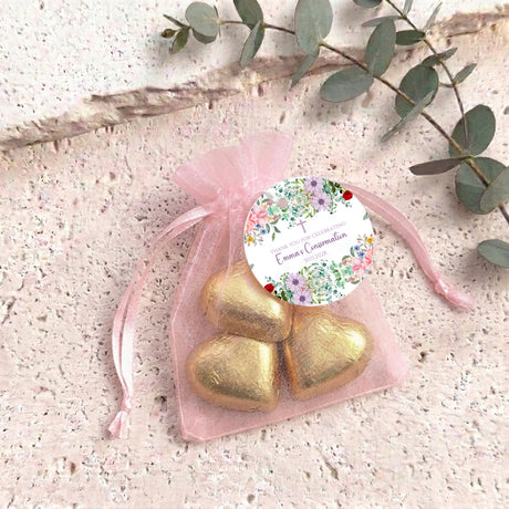 Light pink organza drawstring bag with foil heart chocolates and floral confirmation label