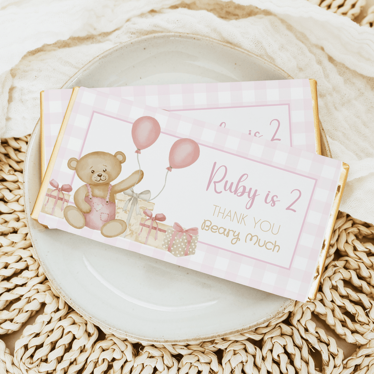 Pink birthday chocolate bar with teddy bear and balloons, 'Ruby is 2' label