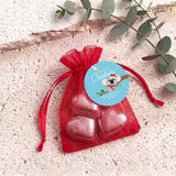 Red heart chocolates in sheer red organza drawstring gift bag with round label
