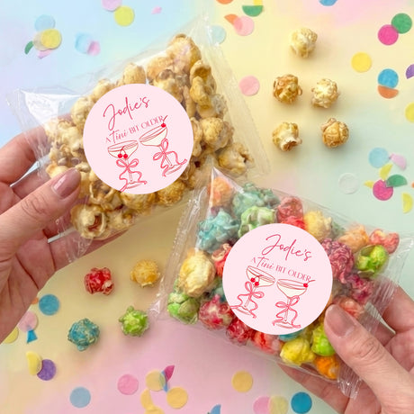 Personalised clear popcorn bag with colorful mini popcorn and round pink label