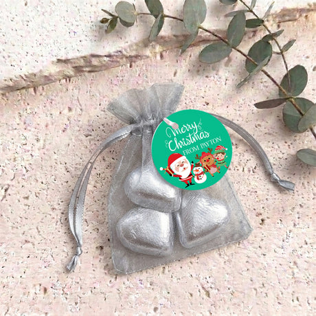 Christmas organza drawstring bag with silver heart chocolates and green round label