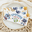 Space birthday chocolate bar wrapper with planets, astronaut, rocket, and 'Spencer turns four'