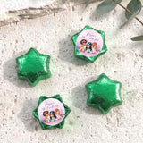 Green foil-covered chocolate stars, with a colorful mermaid birthday label star