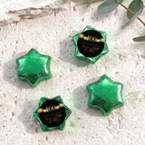Green foil-covered chocolate star sweets with a 100th birthday printed center