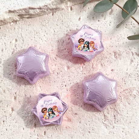 Lavender foil-covered chocolate stars, with a colorful mermaid birthday label star