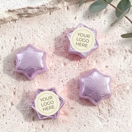 Foil-covered chocolate stars with logo label, purple foil star chocolates