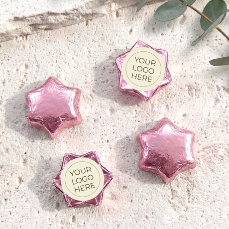 Foil-covered chocolate stars with logo label, pink foil star chocolates