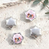 Silver foil-covered chocolate stars, with a colorful mermaid birthday label star