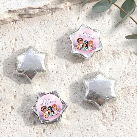 Silver foil-covered chocolate stars, with a colorful mermaid birthday label star