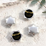 Silver foil-covered chocolate star sweets with a 100th birthday printed center