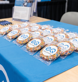 Packaged giant sprinkle cookies, each in clear bag with blue logo sticker
