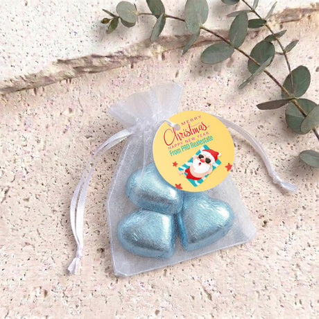 Blue metallic heart chocolates in sheer white organza gift bag with drawstring