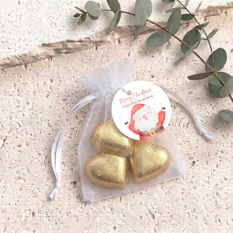 Organza gift bag with gold heart-shaped chocolates and white pull-tie ribbon