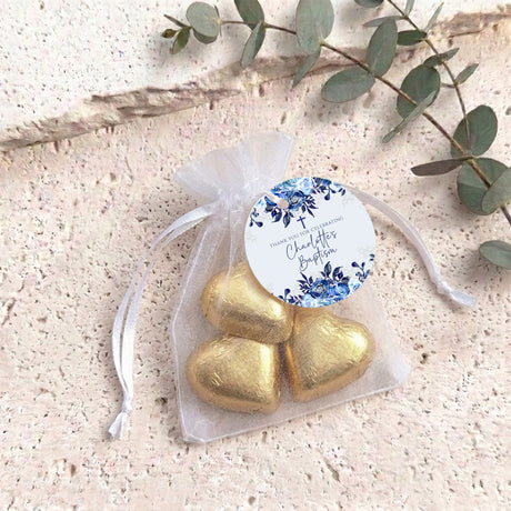 Organza christening bag with gold heart chocolates and blue floral personalized tag