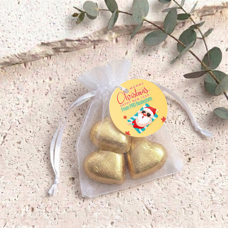 Gold metallic heart chocolates in sheer white organza gift bag with drawstring