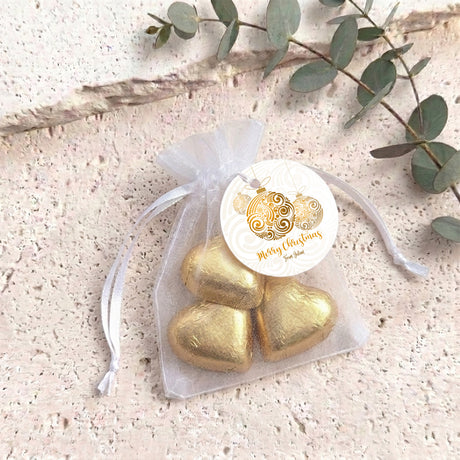 Personalised organza bag with gold heart chocolates and round gift label