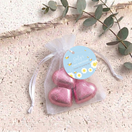 Personalised organza favor bag with pink foil heart chocolates and blue birthday tag