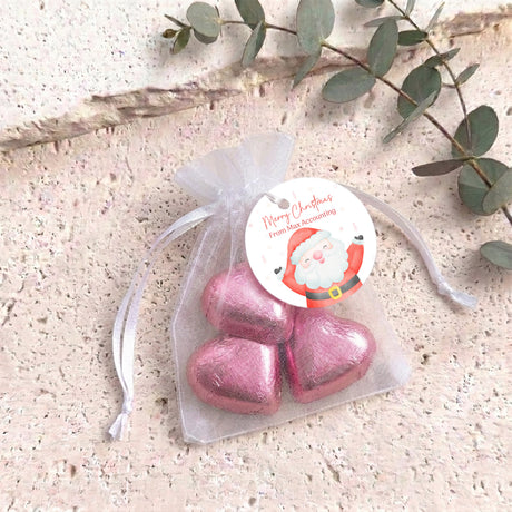 Organza gift bag with pink heart-shaped chocolates and pink pull-tie ribbon