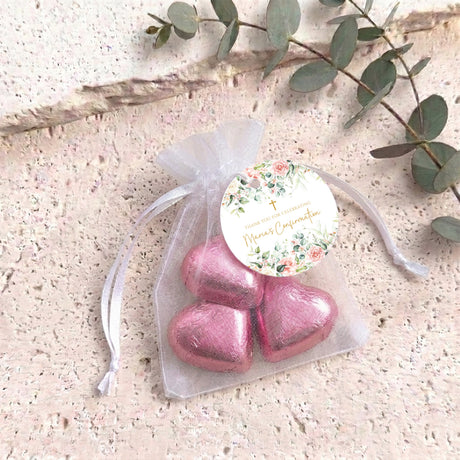 Personalised organza confirmation bag with pink heart-shaped chocolates and ribbon ties