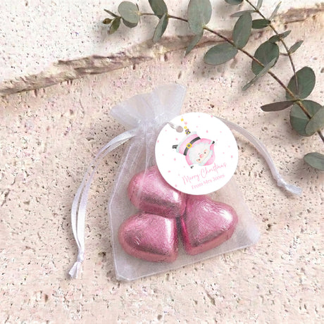 Pink organza gift bag with pink metallic heart chocolates and hanging ribbon