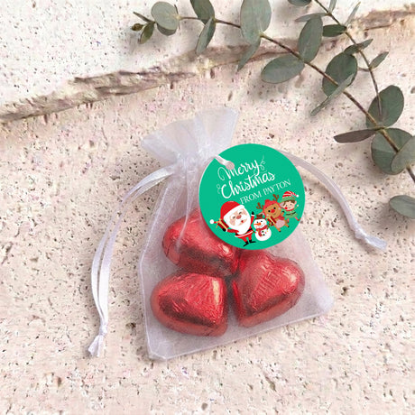 Christmas organza drawstring bag with red heart chocolates and green round label