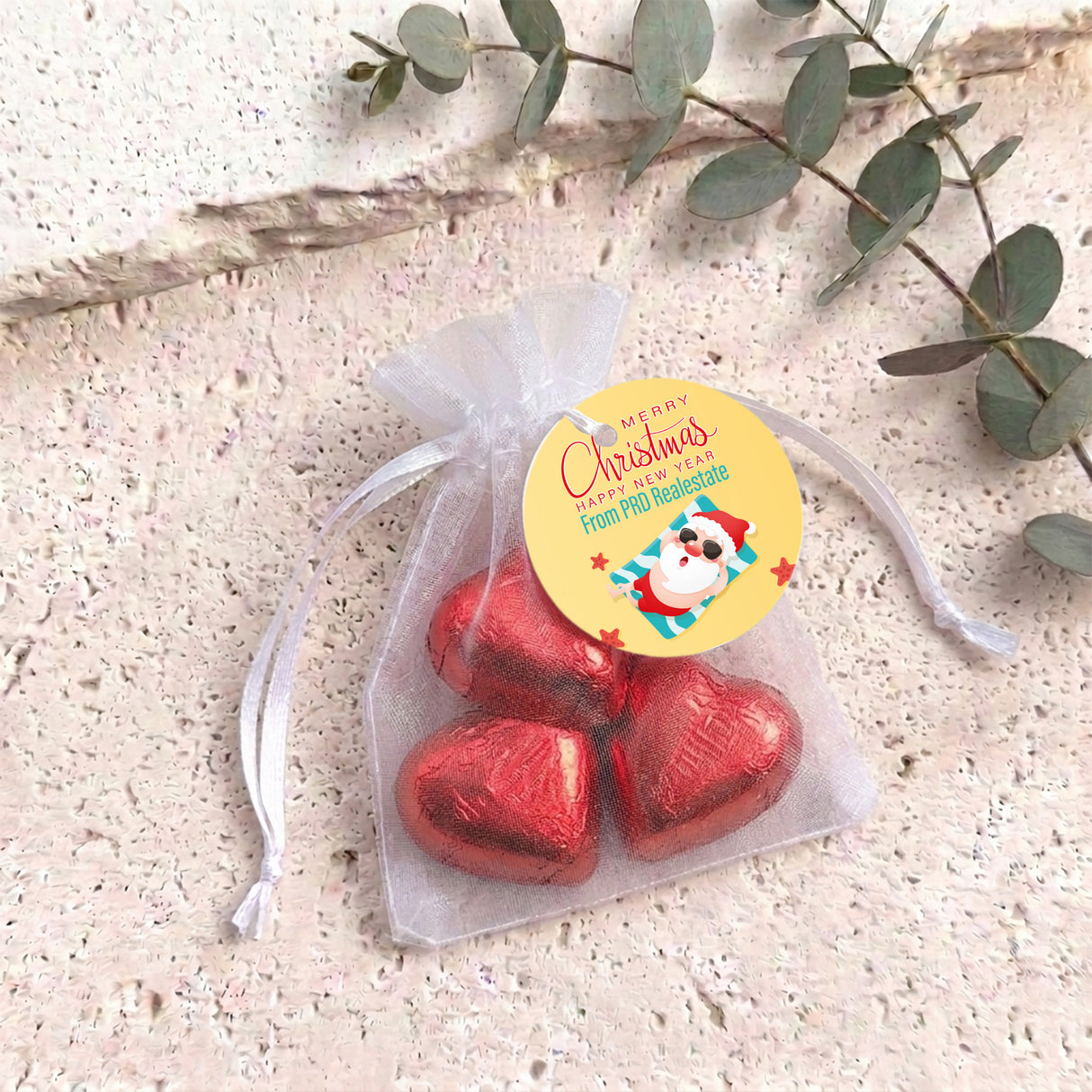 Red metallic heart chocolates in sheer white organza gift bag with drawstring