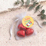 Red metallic heart chocolates in sheer white organza gift bag with drawstring