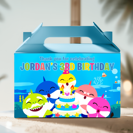Blue gable favor box with colorful Baby Shark birthday scene and candles illustration