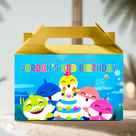 Gold gable favor box with colorful Baby Shark birthday scene and candles illustration