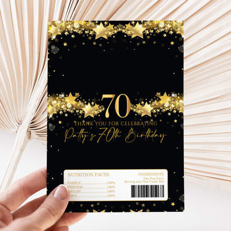 Black chocolate wrapper with gold stars, 70th birthday text, and nutrition facts barcode