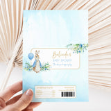 Light blue printed chocolate bar wrapper with rabbit, flowers, and baby shower text