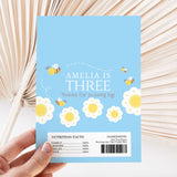 Blue DIY printed chocolate wrappers with bees and flowers, 'Amelia is Three' text