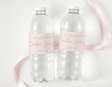 Personalized water bottle labels on clear bottles with pink and red custom text