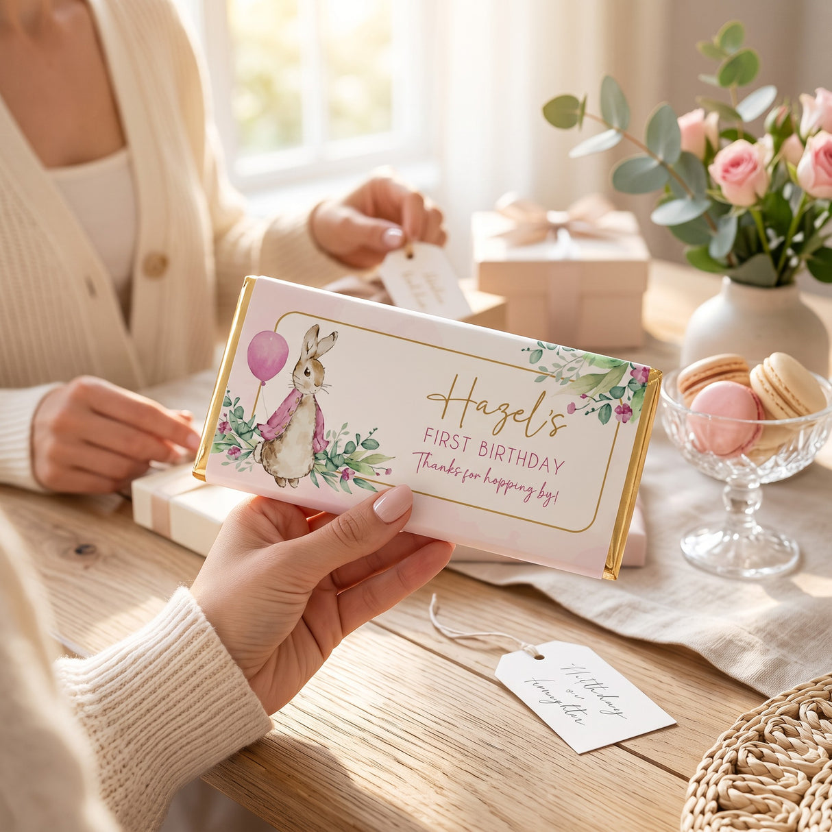 Favour Perfect personalised pink Peter Rabbit chocolate bar for a first birthday party held in a bright room.