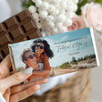 Hand holding personalised wedding chocolate bar with couple photo on teal wrapper