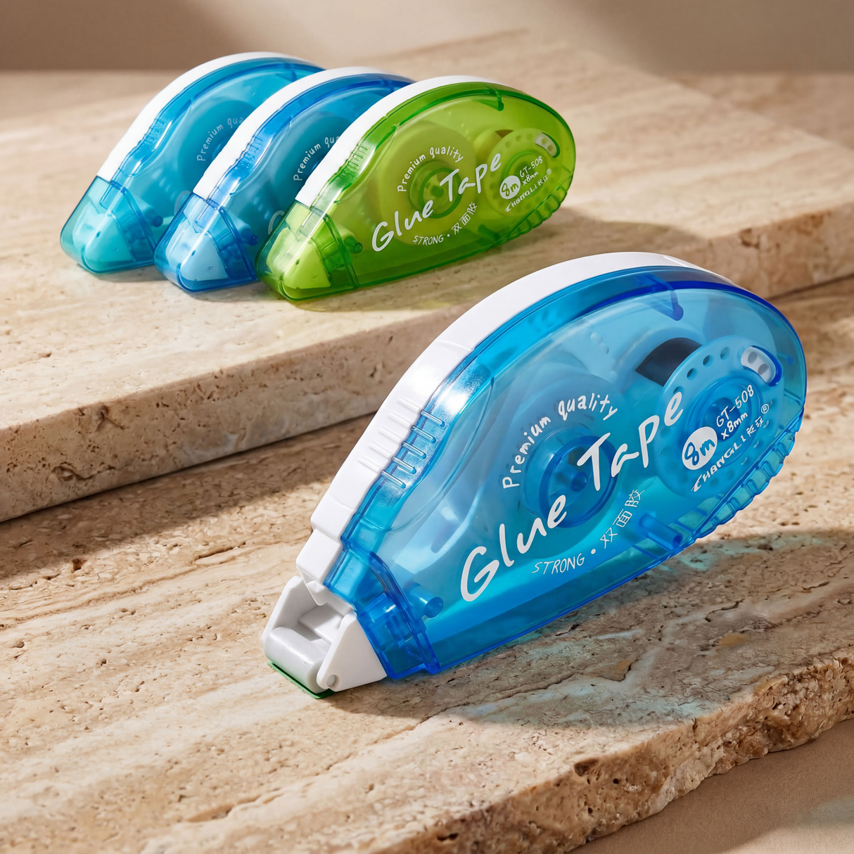 Double-sided tape dispenser with blue and green cartridges
