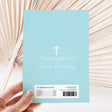 Light blue christening chocolate wrapper with white cross, names, and barcode text